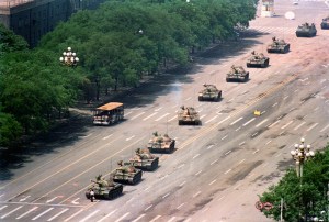 A lone demonstrator stands down a line of Chinese PLA tanks along Changan Ave. near the edge of Tiananmen Square. Beijing 1989. © Charlie Cole